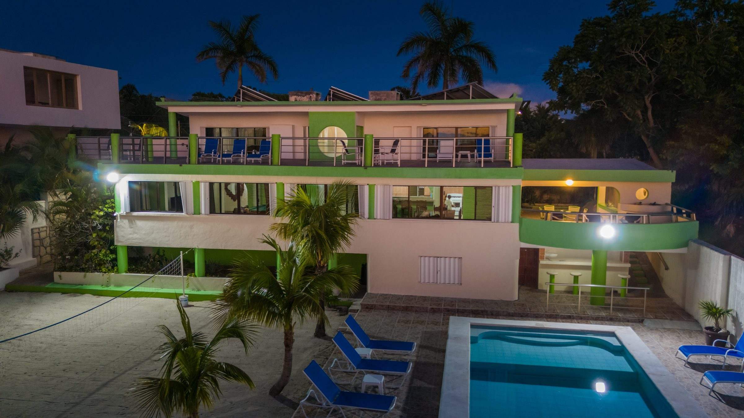 Las Iguanas at blue hour, the house lit and the pool glowing