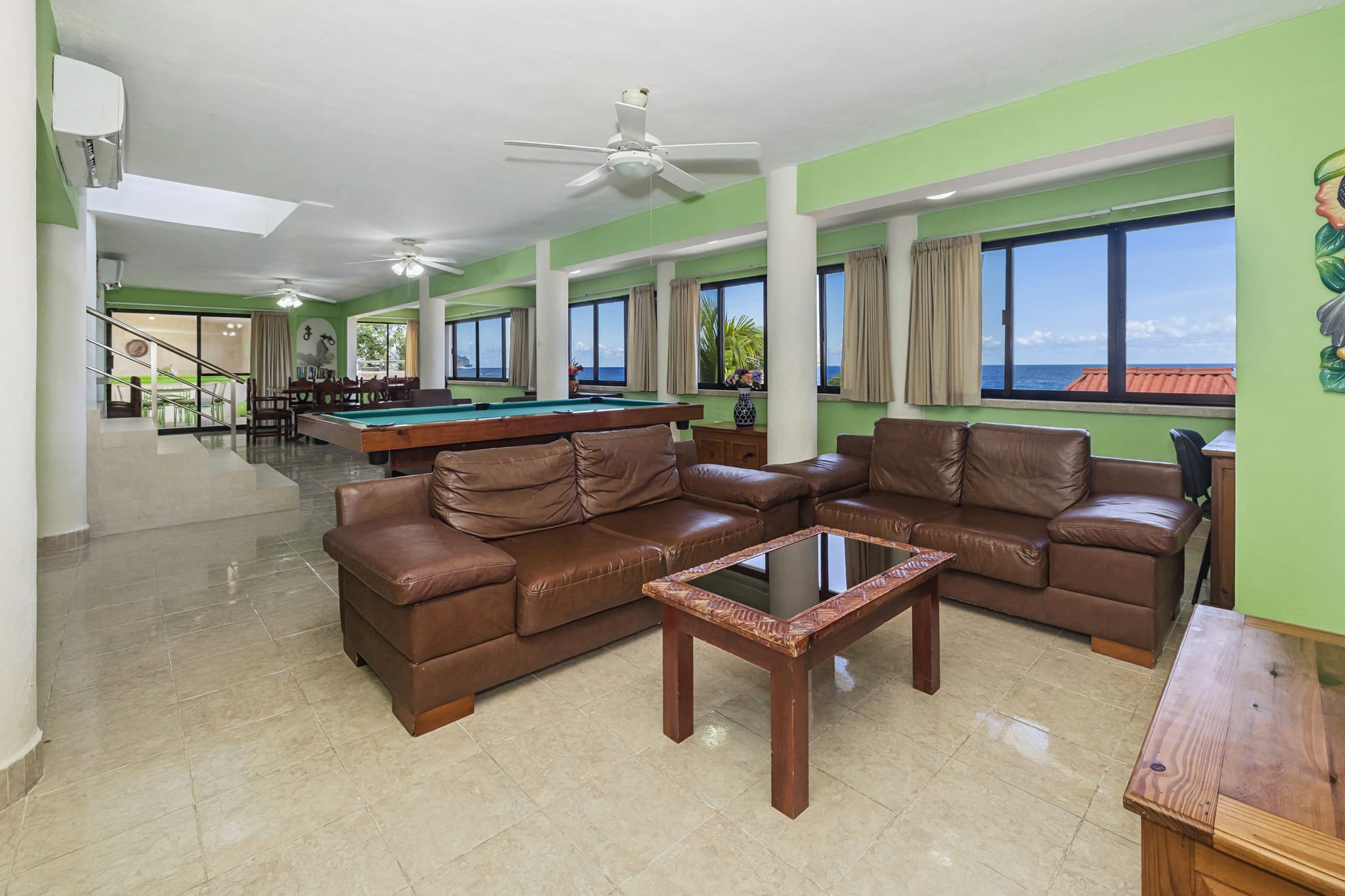 Ocean-view living room with a full-size pool table