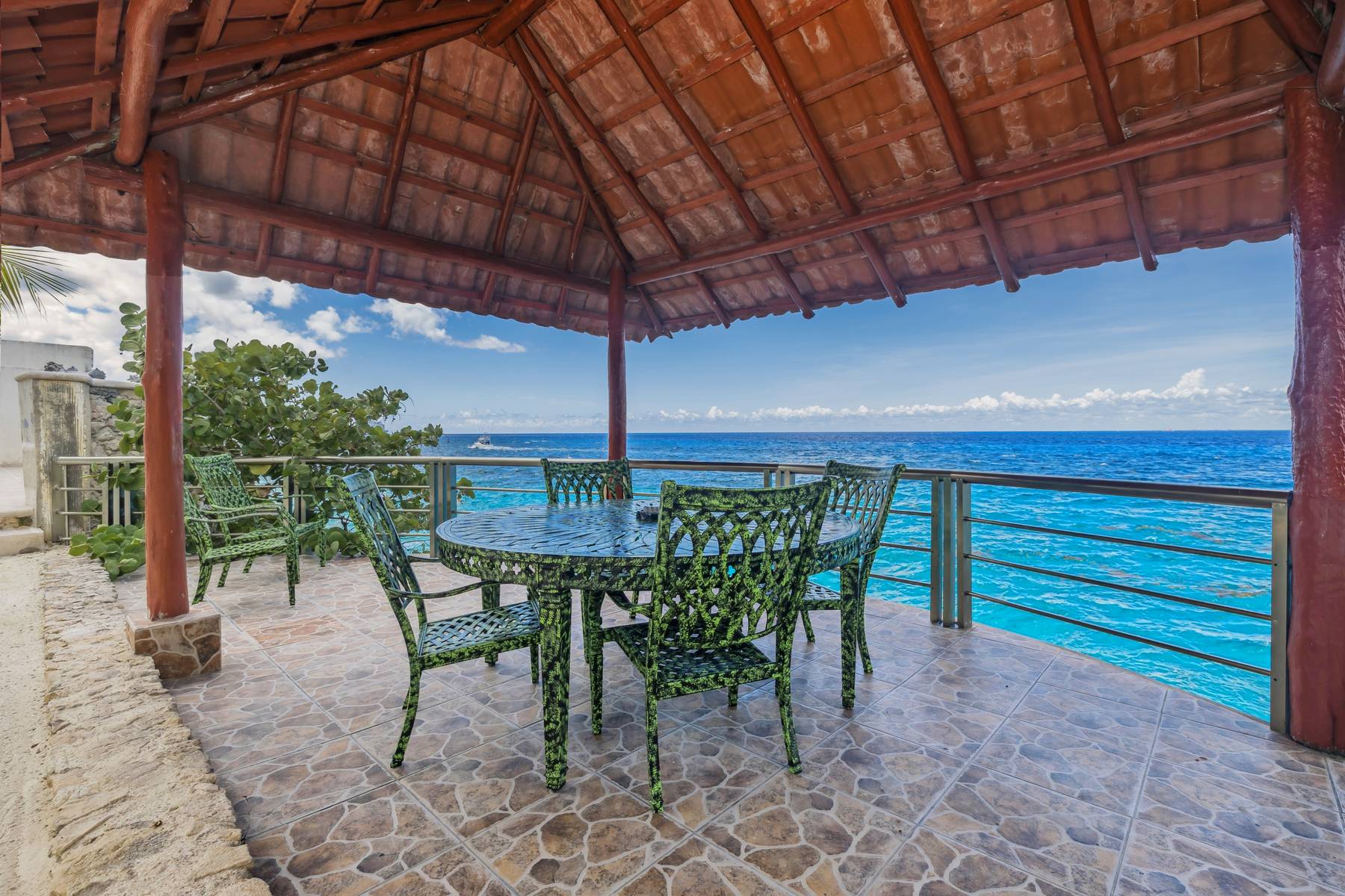 A table laid under the palapa, straight over the sea, at Las Iguanas