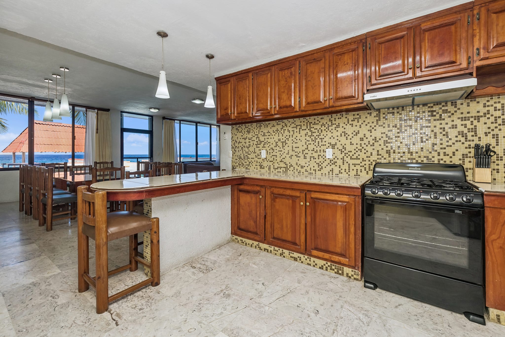 The kitchen and breakfast bar, ocean view beyond