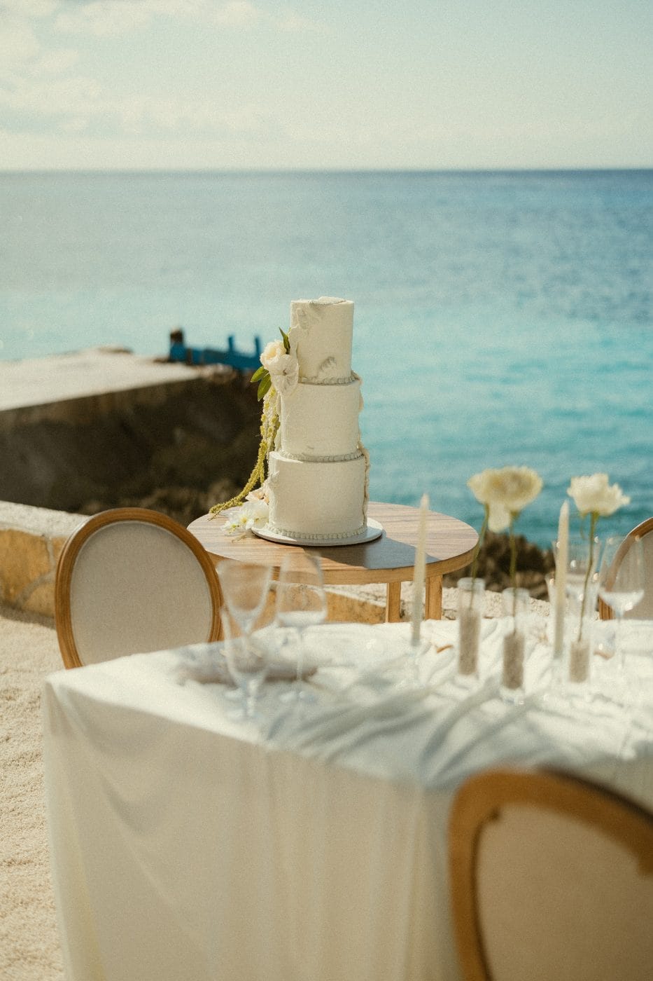 Flowers laid along the sand wall above the coral shore