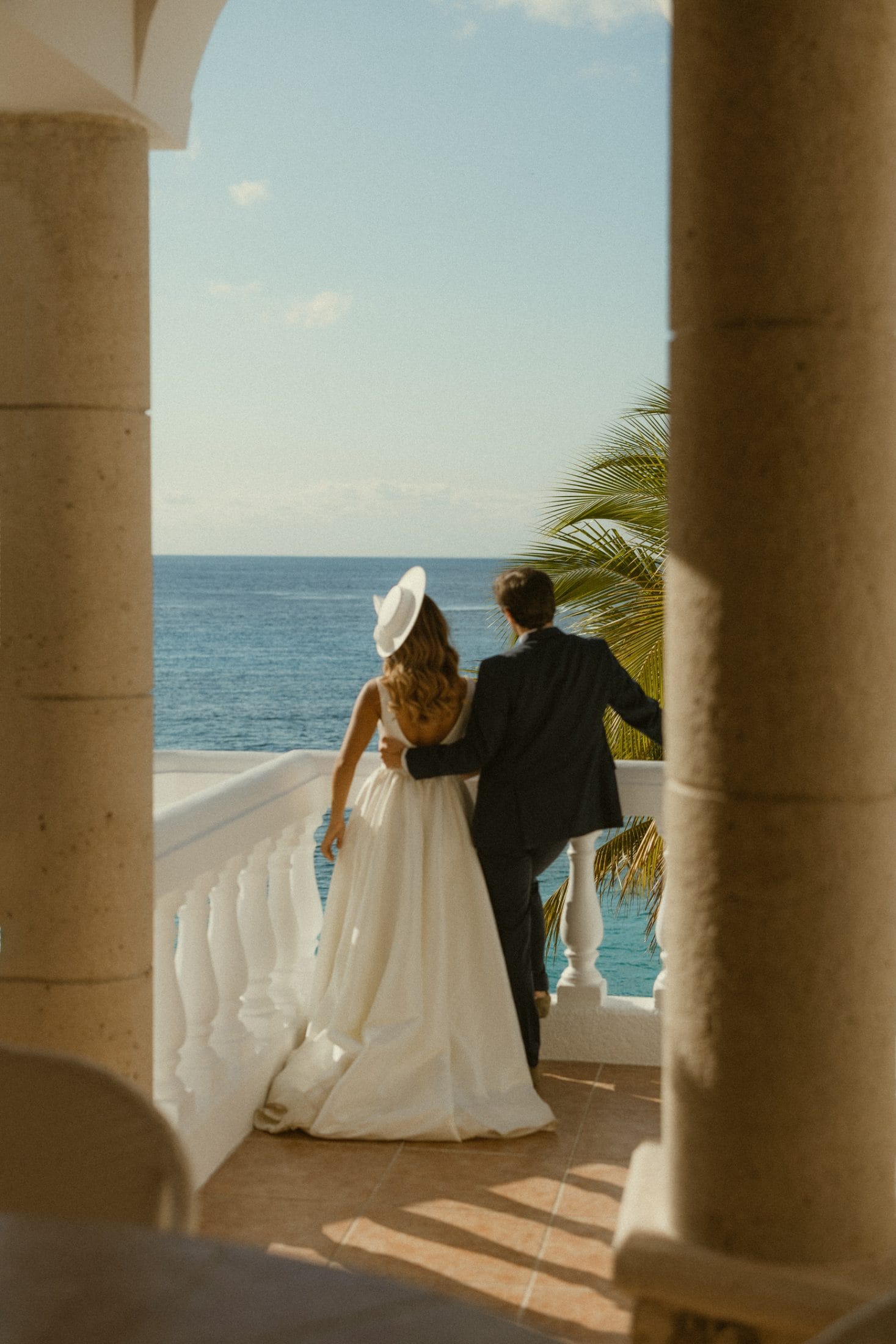 A couple under the brick dome of an Island Casa terrace, looking out at the sea